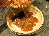 Fill the pie shell with the pecan butter mixture.